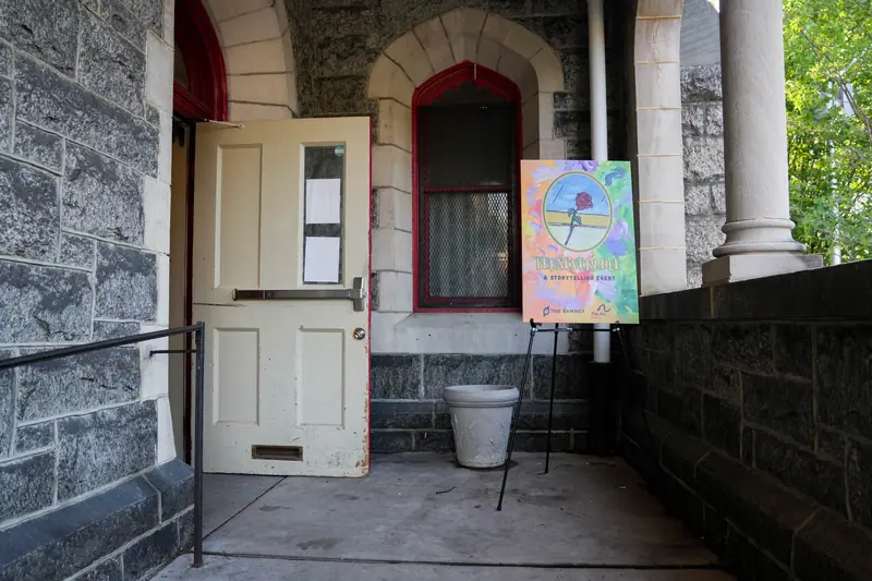 A Perseverance poster on an easel beside the venue's side entrance.