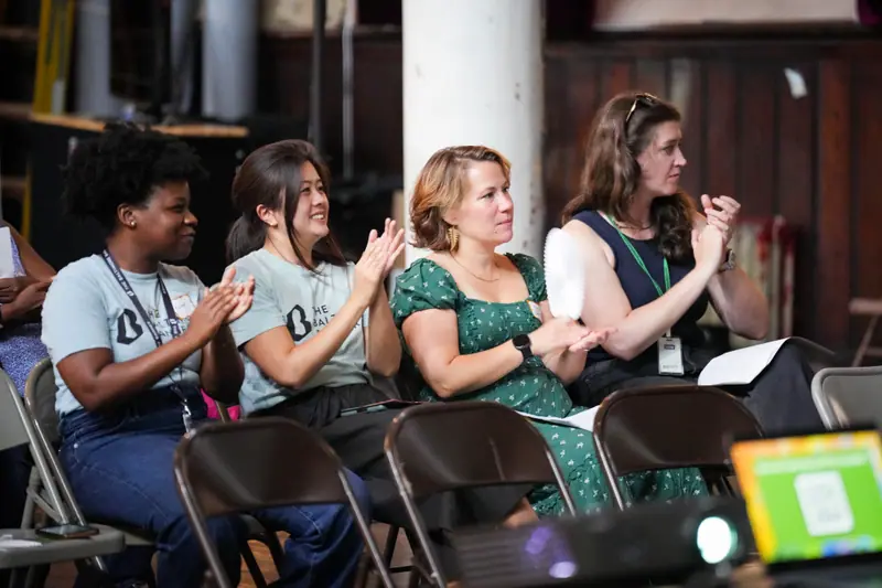 Audience members applaud from their seats at the end of the event.